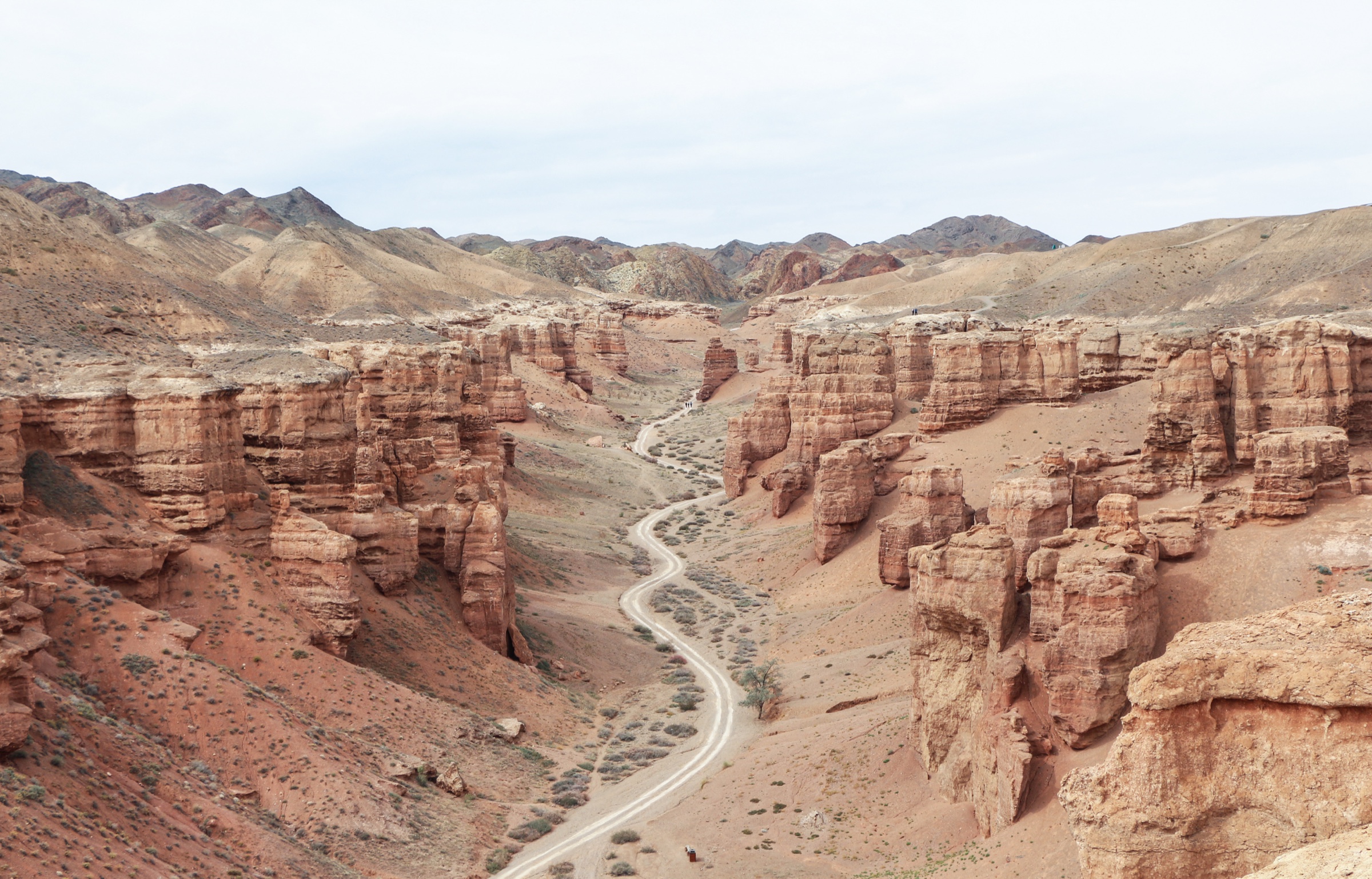 Red sandstone towers of Charyn Canyon with a lone road winding through the Valley of Castles